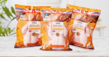 Tesco to remove plastic trays from fresh whole chickens Table top and blurred kitchen room as background